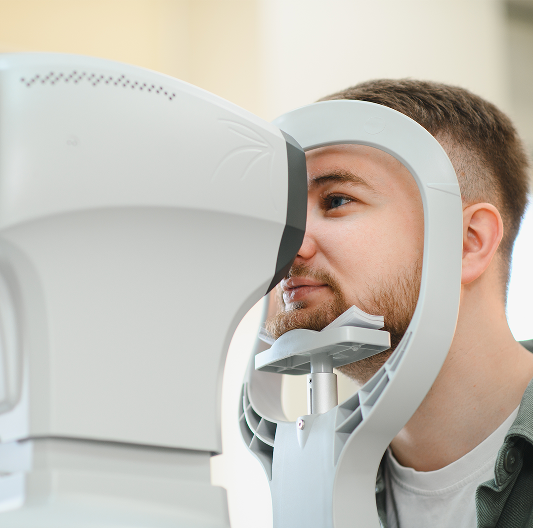 Advanced eye examination at Retina Care of Washington in Gaithersburg, MD Patient Using Eye Diagnostic Equipment